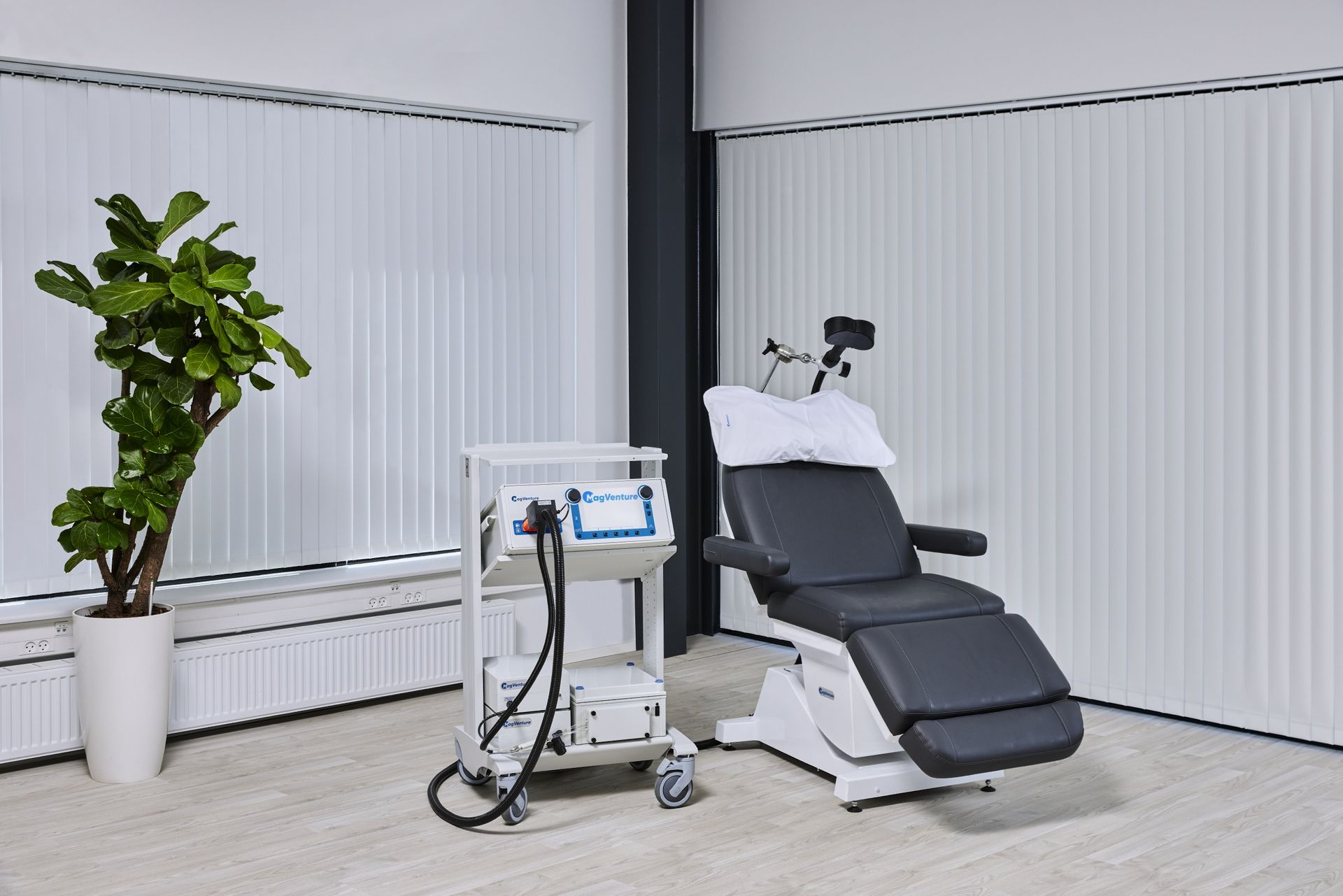 Clínica con camilla y máquina de Paciente siendo tratado con estimulación magnética transcraneal